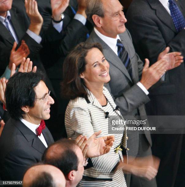 Segolene Royal smiles next to Belgian president of Wallonian Socialist Party and minister-president of Wallonia Elio di Rupo , and Paris' mayor...