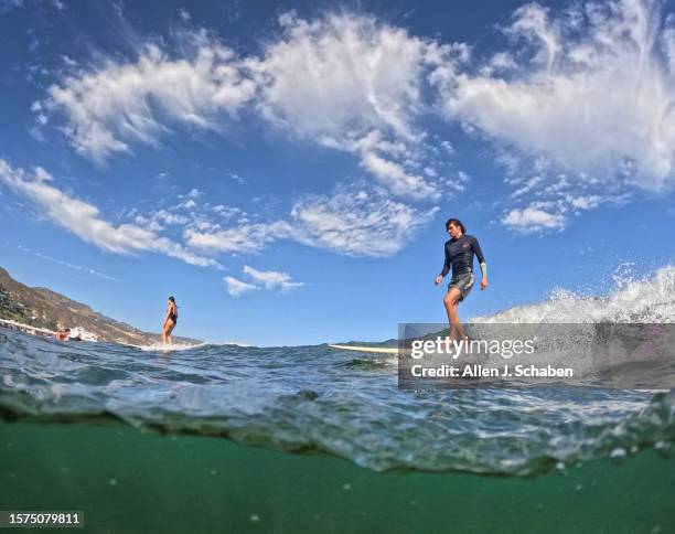 Malibu, CA Ethan Kastenberg, of Agoura hills takes advantage of a good south swell and warm water as he surfs on a hot summer day at Malibu Surfrider...