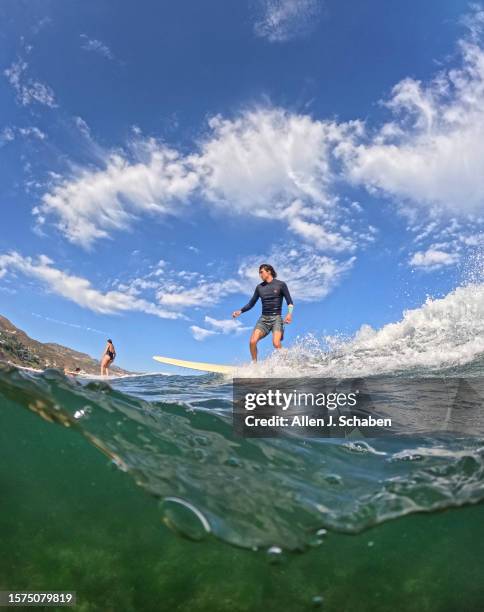 Malibu, CA Ethan Kastenberg, of Agoura hills takes advantage of a good south swell and warm water as he surfs on a hot summer day at Malibu Surfrider...