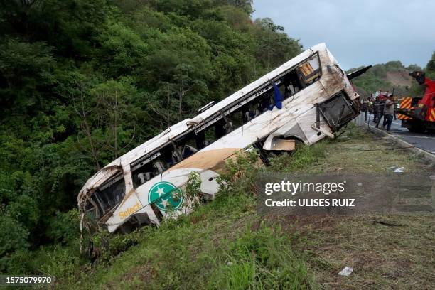 Rescuers work at the site of a road accident in Tepic, Nayarit State, Mexico, on August 3, 2023. At least 18 people were killed and at least 23...