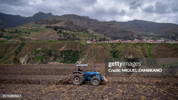 Worker drives a tractor while preparing the land for new crops in Mucuchies, Merida state, Venezuela, on August 3, 2023. Dozens of farmers and...