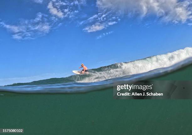 Malibu, CA A surfer takes advantage of a good south swell and warm water as he surfs on a hot summer day at Malibu Surfrider Beach in Malibu Tuesday,...