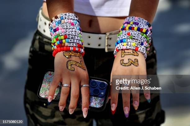 Inglewood, CA Taylor Swift fan Emma Sadeghi, of Glendale, shows her friendship bracelets as she arrives at the emporarily renamed "Speak Now/Taylor's...