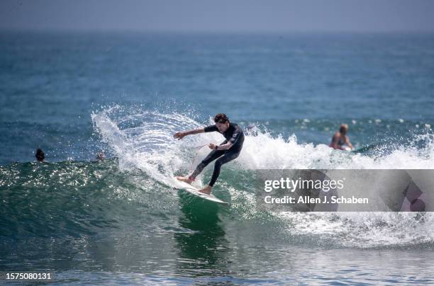 Malibu, CA A surfer takes advantage of a good south swell and warm water as he surfs on a hot summer day at Malibu Surfrider Beach in Malibu Tuesday,...