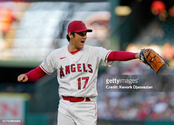 Starting pitcher Shohei Ohtani of the Los Angeles Angels reacts after throwing to second base to throw out Cade Marlowe of the Seattle Mariners on a...