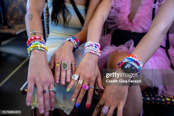 Taylor Swift fans Izzy Taylor left, of Utah and Kenna Bringhurst of Utah show off their friendship bracelets while riding the Metro Rail to pick up a...
