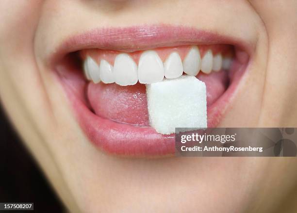 würfelzucker in mouth - sugar stock-fotos und bilder