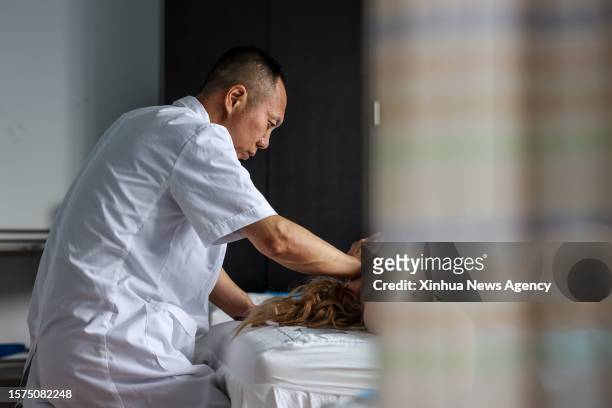 Doctor performs a traditional Chinese medicine therapy on a Russian patient at a hospital in Hunchun, northeast China's Jilin Province, June 28,...