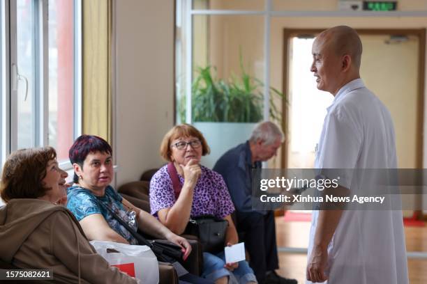 Doctor talks with patients at a hospital in Hunchun, northeast China's Jilin Province, June 28, 2023. Hunchun is located at China's border with...