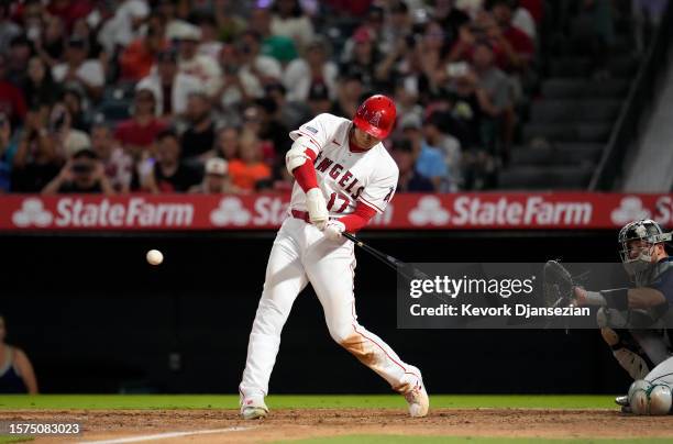 Designate hitter Shohei Ohtani of the Los Angeles Angels hits a one run home run against Seattle Mariners during the eight inning at Angel Stadium of...