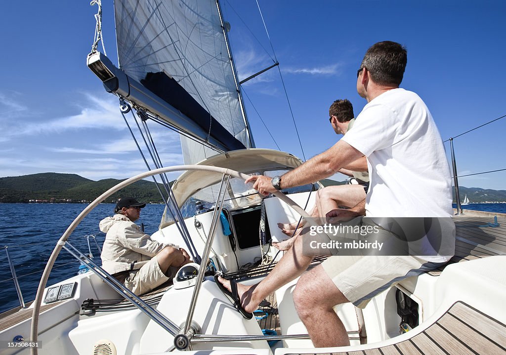 Sailing crew on sailboat