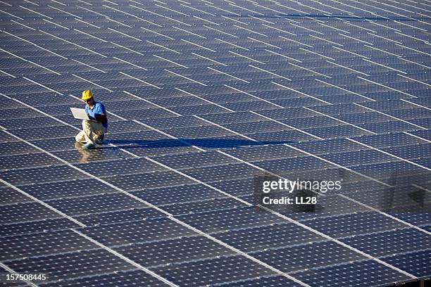 an engineer working at a photovoltaic farm - solar power station stock pictures, royalty-free photos & images