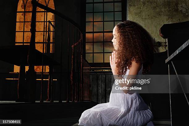 little girl praying in church. - child praying stock pictures, royalty-free photos & images