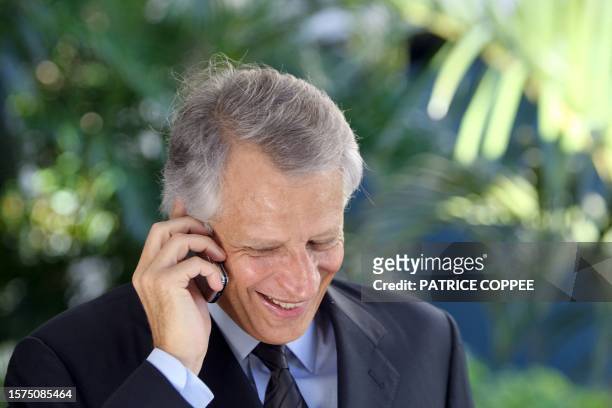 Former French Prime minister Dominique de Villepin gives a phone call during his visit in Martinique French island in the eastern Caribbean Sea on...