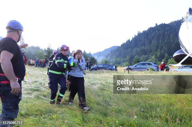 Search and rescue teams conduct operation by a helicopter after floods and landslides in the resort town Shovi, Racha-Lechkhumi region of Georgia on...
