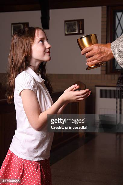 girl receiving holy communion - receiving communion stock pictures, royalty-free photos & images