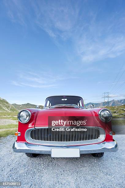 blue sky over red oldtimer car - license plate stockfoto's en -beelden