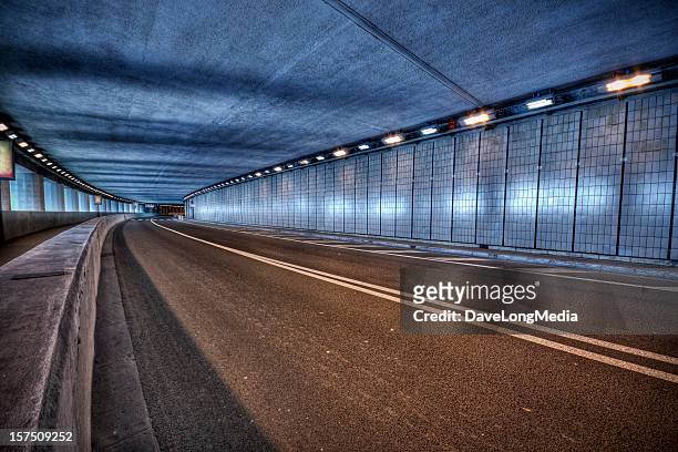 blue toned illuminated monaco grand prix tunnel at night - monaco stock pictures, royalty-free photos & images