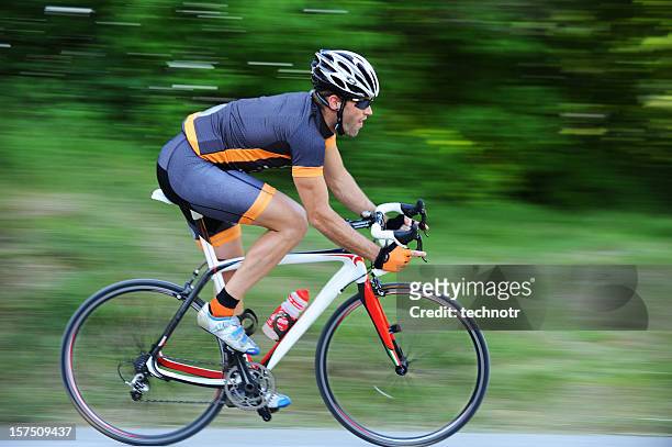 cyclist in the action - racing bicycle stock pictures, royalty-free photos & images