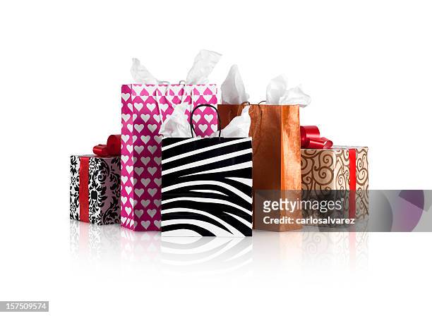 stacks of shopping bags and gift boxes on a table  - christmas gift bag stock pictures, royalty-free photos & images