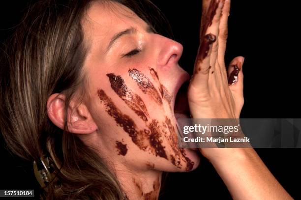 suralimentation, chocolat joy - woman hand face photos et images de collection