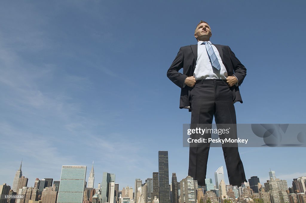Confident Businessman Giant Towering Over City Skyline