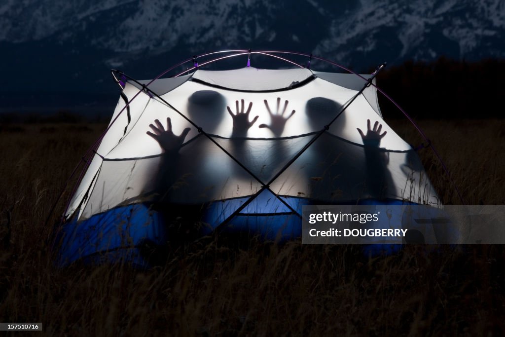 Silhouettes in a tent