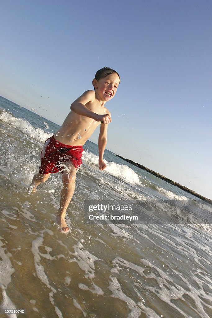 Child running in sea