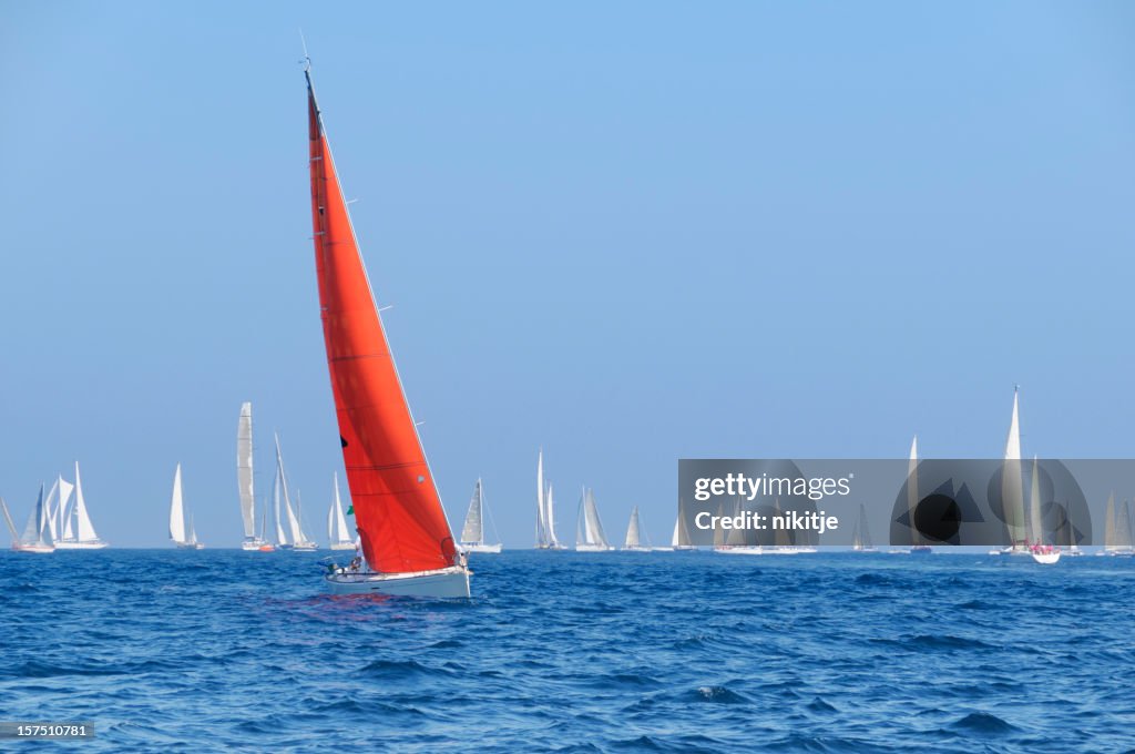 Boat with a red sail during the sailin competition