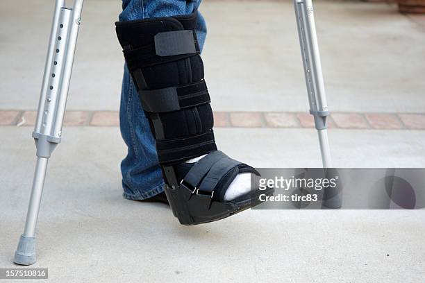 mature man on crutches - cast stockfoto's en -beelden