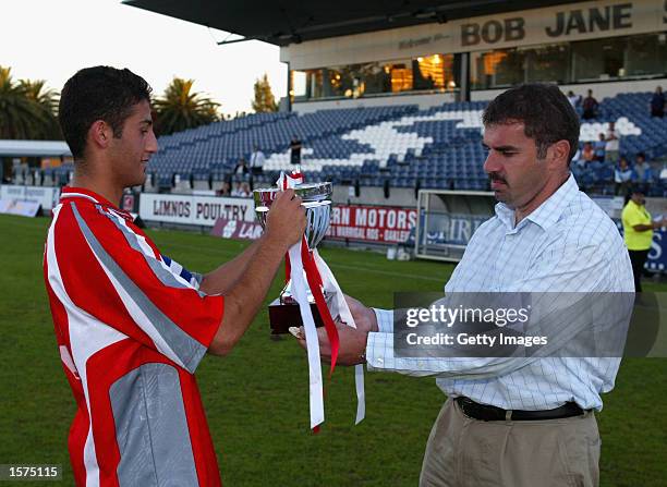 Ramazan Tausancioglu, captain of the Melbourne Knights accepts the trophy from Ange Postecogolou after winning the National Youth League Southern...