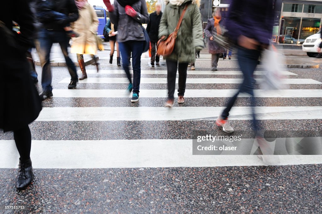 Young people crossing street, motion blur