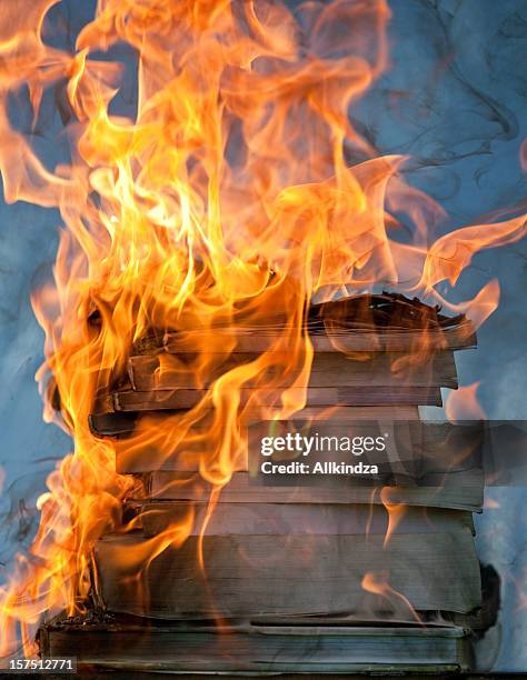 stack of burning books iii - book burning stock pictures, royalty-free photos & images