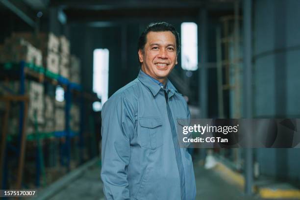 asian malay mature man factory manager looking at camera smiling - malay people stock pictures, royalty-free photos & images