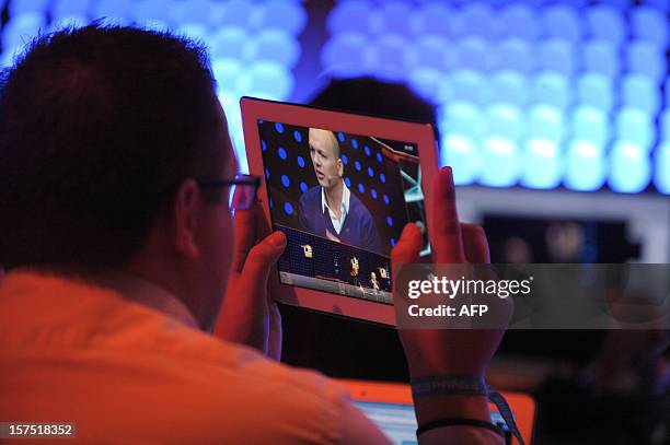 Participant listens to Tony Fadell, Founder and CEO of Nest Labs, Inc on December 4, 2012 during the opening session of LeWeb12 in Saint-Denis, near...