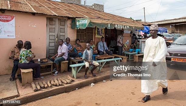 Street scene with locals sitting outside a street cafe in Yaounde, Cameroon on October 29, 2012.