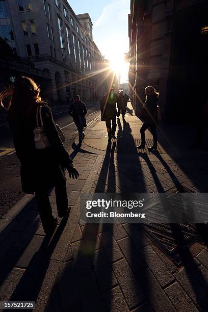 Pedestrians cross an intersection in the financial district in London, U.K., on Friday, Nov. 30, 2012. U.K. Banks have become more unwilling to...