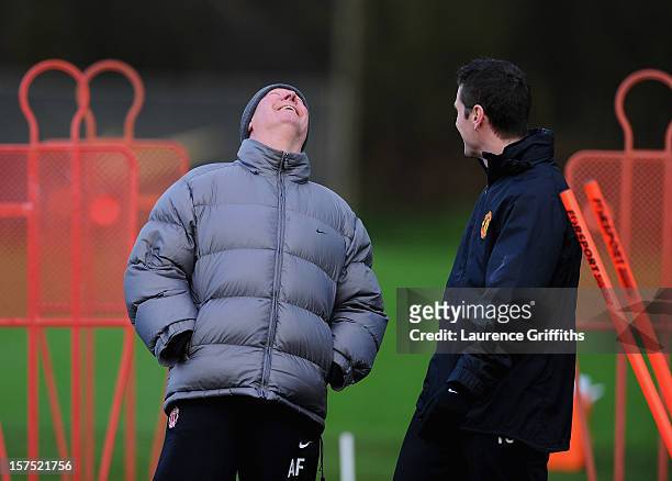 Sir Alex Ferguson of Manchester United shares a joke during a training session ahead of their Champions League Group H match against CFR 1907 Cluj at...