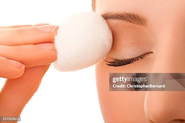 female using cotton ball to remove eye make-up - woman applying cotton ball bildbanksfoton och bilder