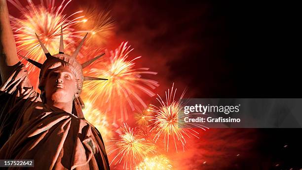 fireworks behind statue of liberty - new years eve new york city stock pictures, royalty-free photos & images