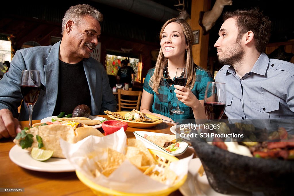 Dinner Group at Nice Restaurant Eating Together