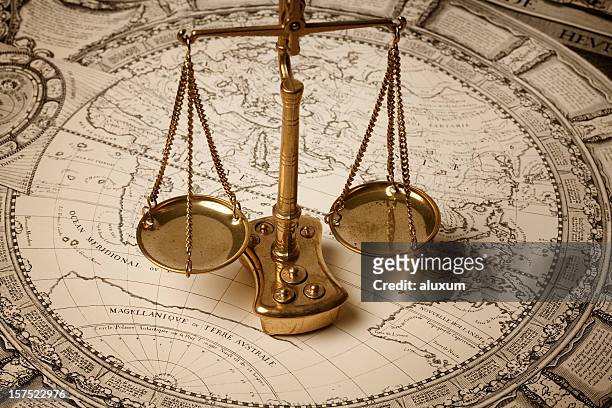 scale of justice on ancient map - law scales stock pictures, royalty-free photos & images