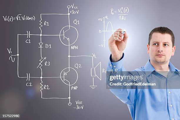 an electronics engineer drawing a circuit on glass wall - resistor stock pictures, royalty-free photos & images