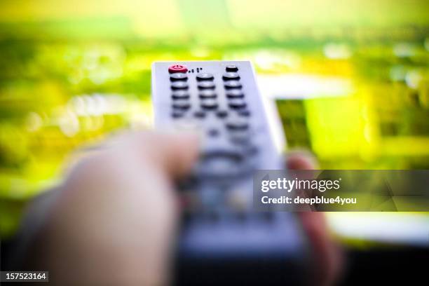 media cencept - hand holding remote tv background - radio controlled handset stock pictures, royalty-free photos & images