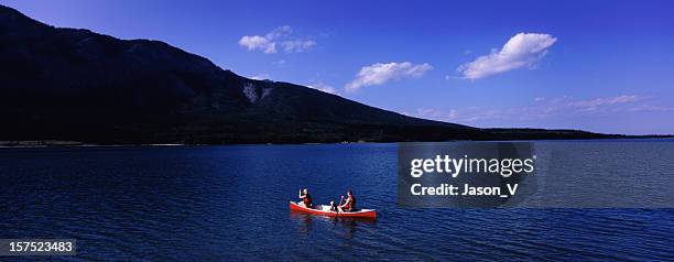 family canoeing in the rockies - family red canoe stock pictures, royalty-free photos & images