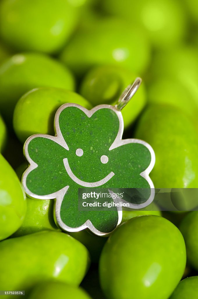 Green four-leaf clover shaped silver pendant.