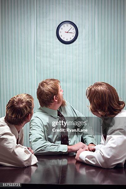 impatient businessmen looking up at the clock - impatient stock pictures, royalty-free photos & images