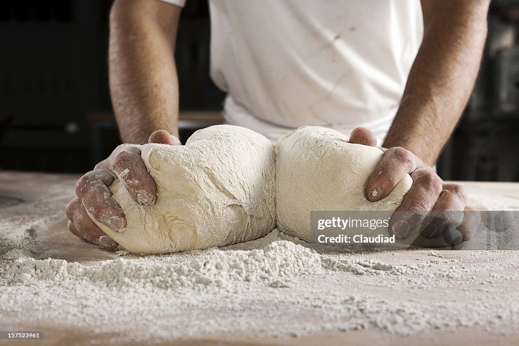 Hands kneading dough