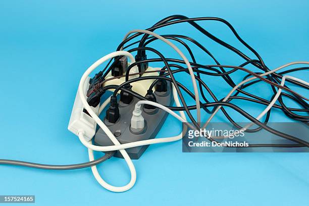 electrical cord overload - electrical outlet stock pictures, royalty-free photos & images