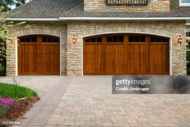 pavers, custom doors, and stone on upscale home. - block paving driveway stock pictures, royalty-free photos & images